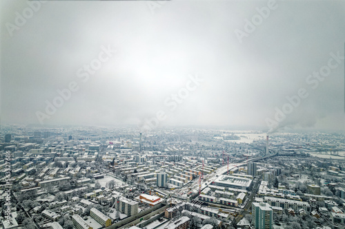 Aerial view over snow covered City of Zürich with skyline and gray cloudy winter sky on a snowy late autumn day. Photo taken December 17th, 2022, Zurich, Switzerland.