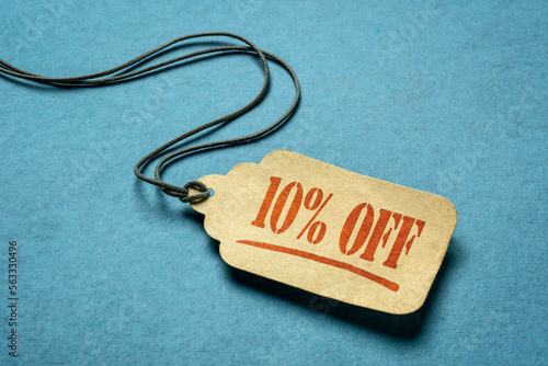 10 percent off - a paper price tag against blue background, sale, discount and shopping concept