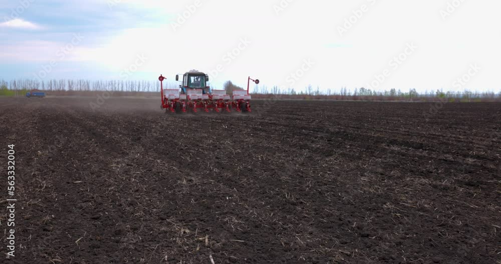 Seeding Machine Working in Field on the Farm. Agriculture. Tractor Seeder it Plants Seeds in the Ground. Slow motion. Tillage Equipment. Seeding Machine Working in Field on the Farm. Agriculture. Tractor Seeder it Plants Seeds in the Ground. Slow motion. Tillage Equipment.
