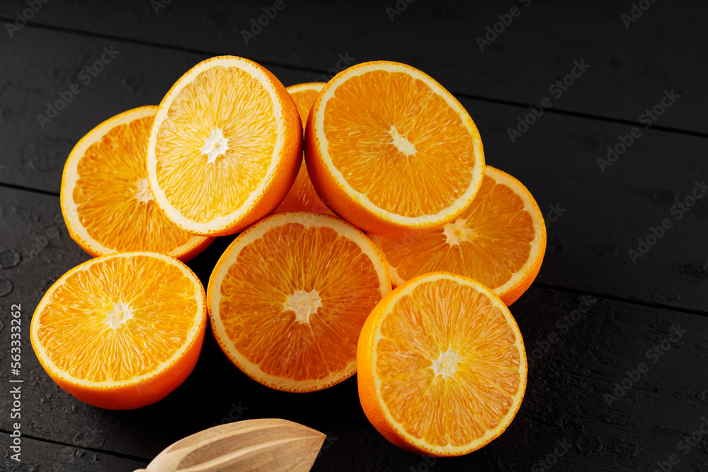Fresh ripe oranges on a dark wooden table. Fresh citrus fruits for vegetarian dishes Fresh ripe oranges on a dark wooden table. Fresh citrus fruits for vegetarian dishes