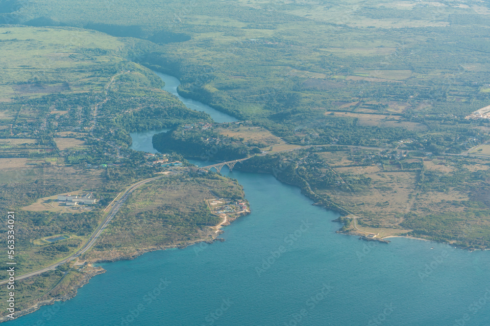 Aerial landscape view of the area around the estuary of river Rio Canimar in Matanzas, Cuba with a massive bridge construction connection the coastal road on both sides of the river