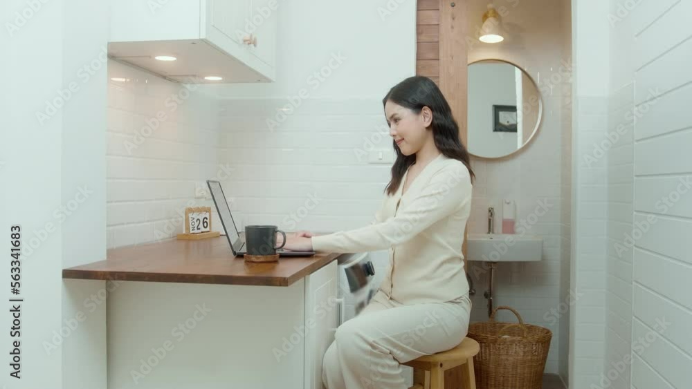 An Asian young woman using laptop computer online working at home , lifestyle and teleworking concept An Asian young woman using laptop computer online working at home , lifestyle and teleworking concept