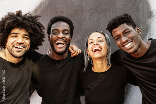 Happy group of multiracial people having fun laughing in front of camera outdoor