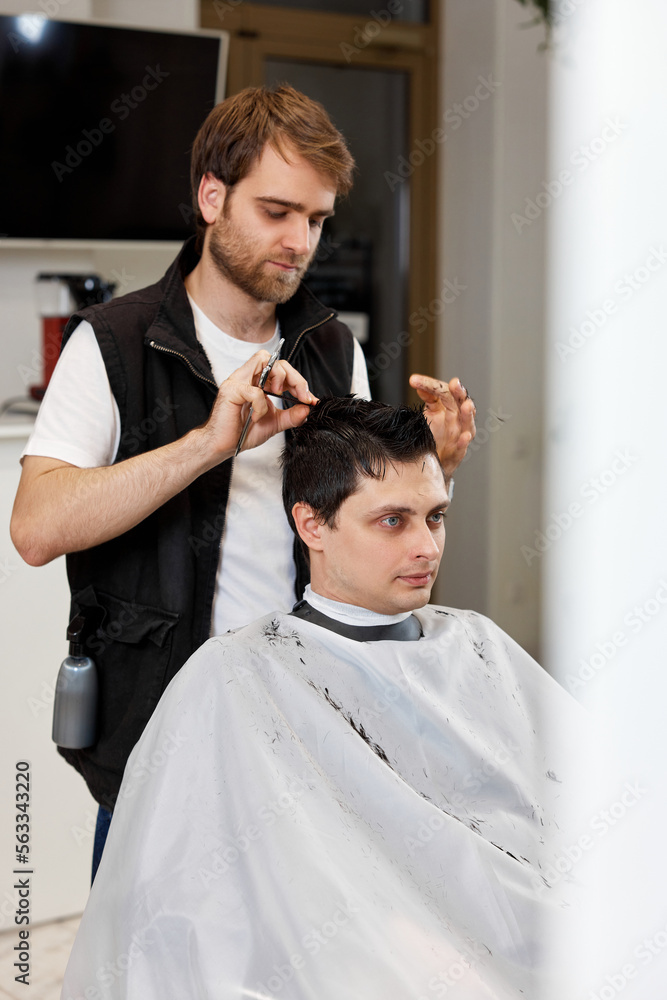 hairdresser does haircut for caucasian bearded man hairdresser does haircut for caucasian bearded man