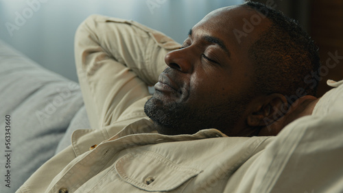 Photos Headshot calm relaxed happy african american man relax resting on couch enjoying