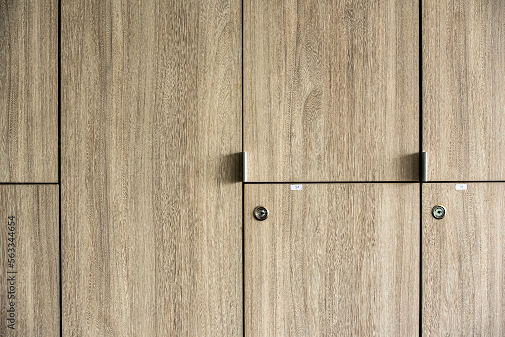 Naklejka premium Wooden lockers with key in locker room at school sport club office.