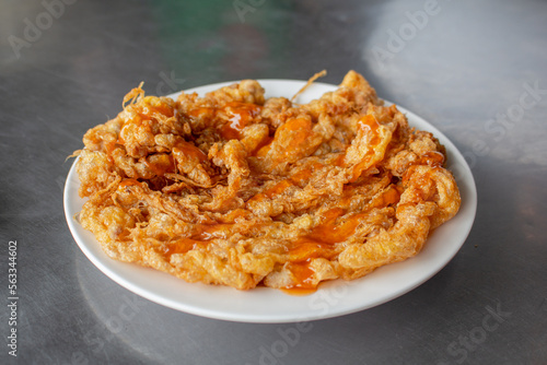 Thai style omelette - fried beaten egg served with chili sauce