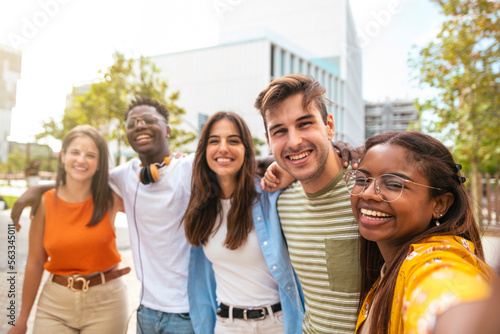 Fotografie Multiracial group of friends making a selfie with phone in the university - frie