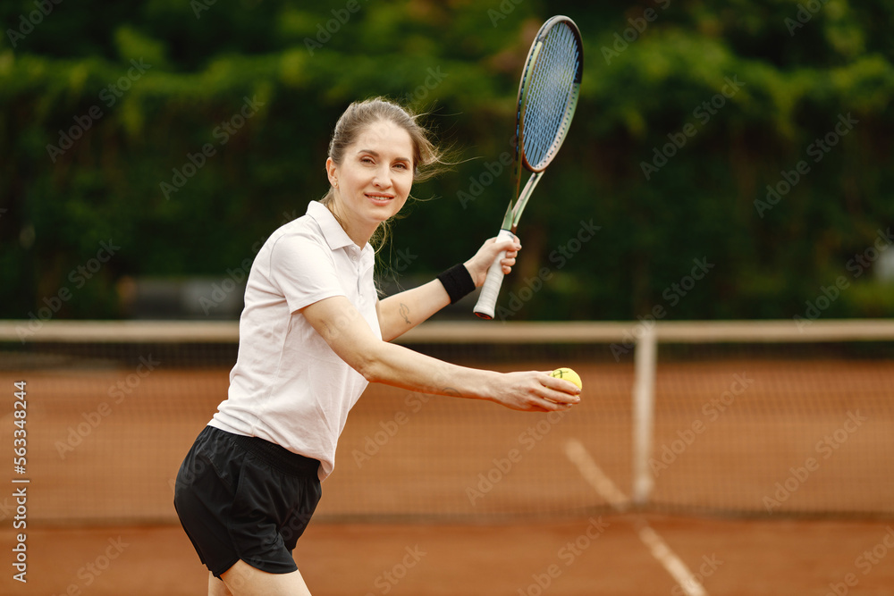Female tennis player playing tennis on an open tennis court