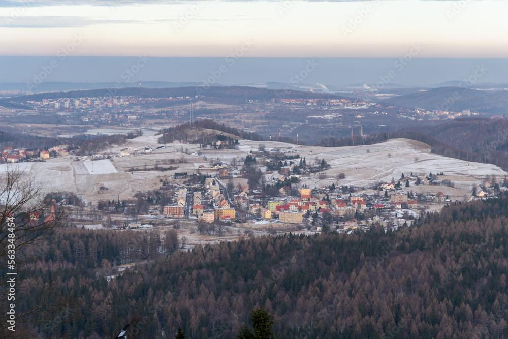 Panoramic view from the top of Dzikowiec Mountain, in Boguszow-Gorce near Walbrzych in Poland. Branches in foreground, selective focus. Popular viewing tower.