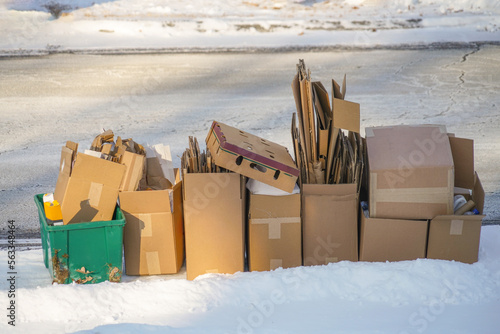 stacking cardboard boxes for curbside recycle photo