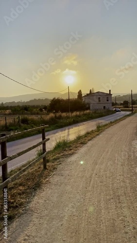 Bicycle route on path along a country road at sunset. photo