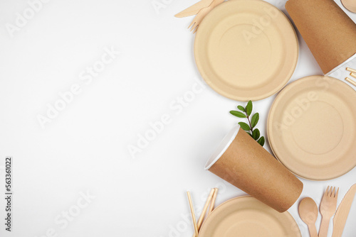 Eco friendly disposable dishware for takeout. Side border on a white background. Biodegradable  composable alternative to plastic. Top down view with copy space.