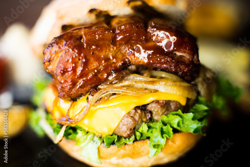 Premium Authentic American Burger with a tender pork rib on top.