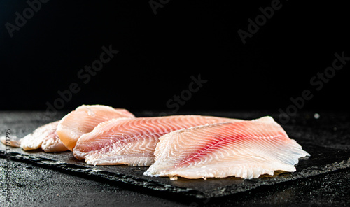 Uncooked fish fillet on the table. 