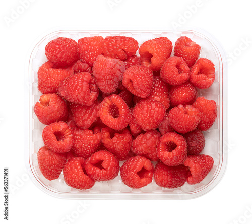 Whole fresh raspberries, in a clear plastic punnet, from above. Ripe, red and sweet fruits of Rubus idaeus, the cultivated European raspberry. Organic and vegan fruits. Isolated, close-up, food photo.