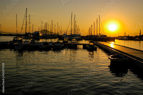 Fototapeta Naklejka Na Ścianę i Meble -  Procida Harbor at sunrise with seas calm and no wind.
