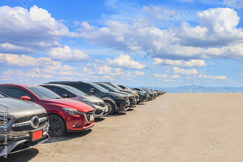 Lot of used car for sales in stock with sky and clouds