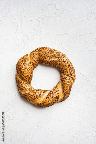 Turkish street food circular bread, bagel with sesame, on white stone table background, top view flat lay, with copy space for text