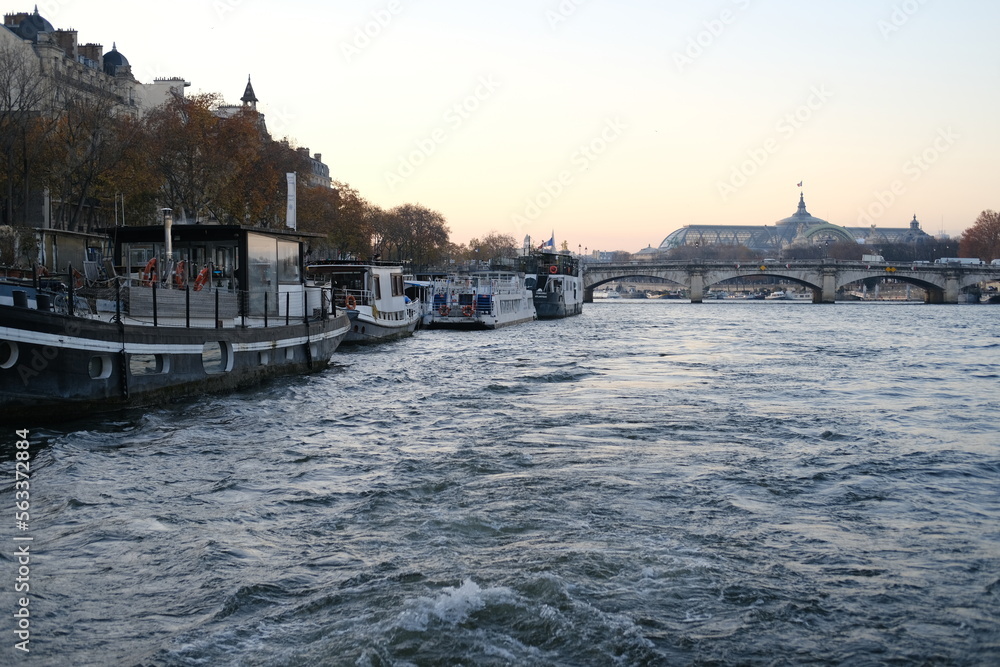 Fototapeta premium A view of the Seine river during dusk. December 2022, Paris, France.
