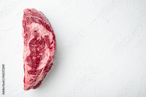 Freshly cut boneless ribeye big piece cut, on white stone background, top view flat lay, with copy space for text