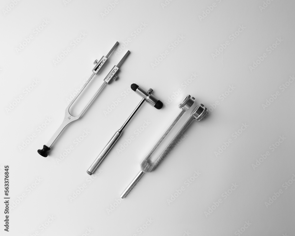 tuning fork C 128 on a white background with gradation and neurological hammer tuning fork C 128 on a white background with gradation and neurological hammer