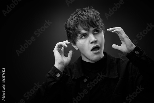 crazy young man with awesome hairdo grimacing