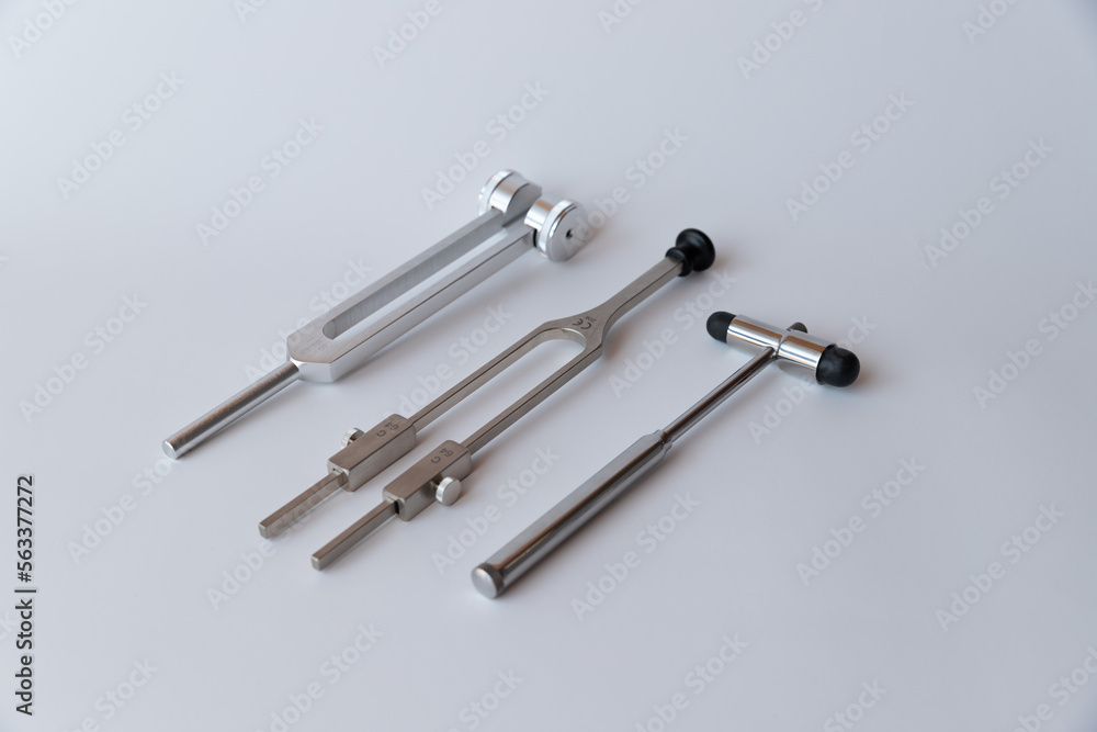 tuning fork C 128 on a white background with gradation and neurological hammer tuning fork C 128 on a white background with gradation and neurological hammer