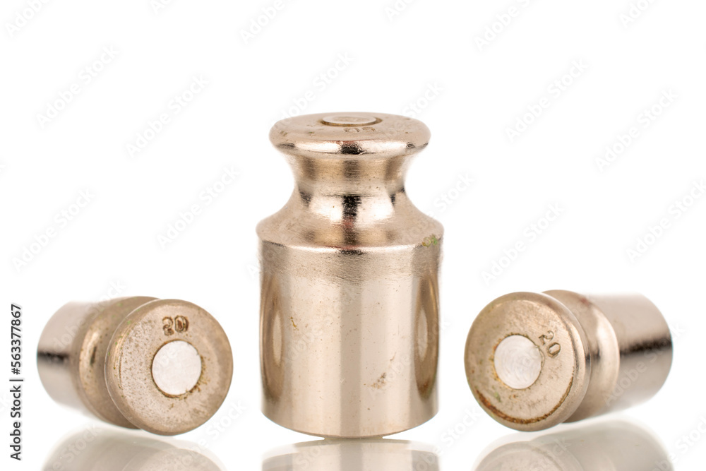 Three metal weights for old jewelry scales, macro, isolated on white background. Three metal weights for old jewelry scales, macro, isolated on white background.