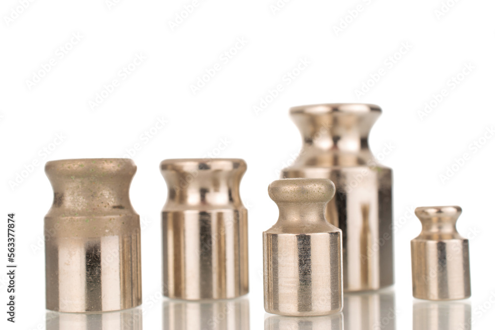 Several metal weights for old jewelry scales, macro, isolated on white background. Several metal weights for old jewelry scales, macro, isolated on white background.
