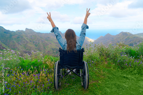 Φωτογραφία Disabled handicapped woman in wheelchair on mountain hill enjoying view