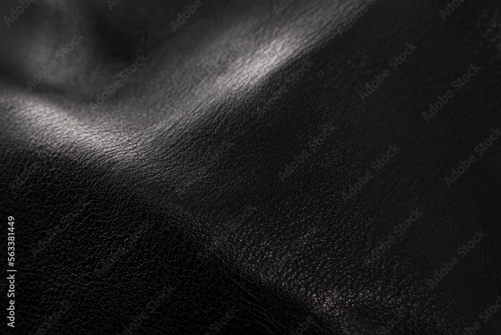 Black leather texture. Abstract background of dark leather with small roughness and scuffs Black leather texture. Abstract background of dark leather with small roughness and scuffs