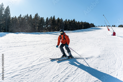 Photos A boy skiing down a large ski slope.