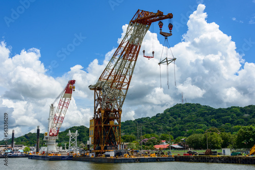 Titan Herman the German dwarfs the Huisman floating crane on the Panama canal photo