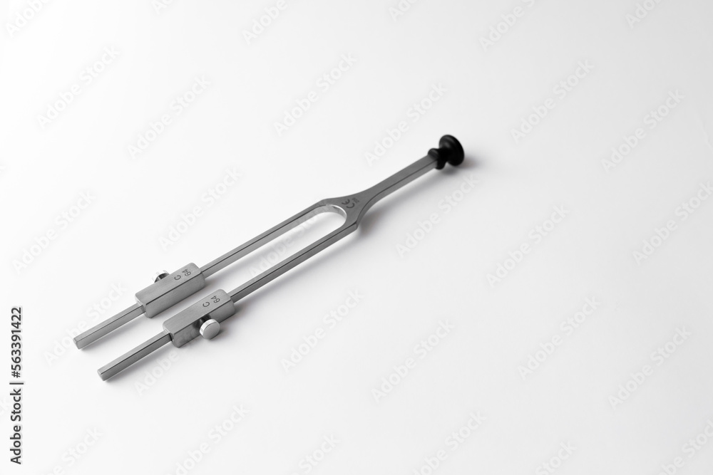 tuning fork C 128 on a white background with gradation, medical instruments, equipment tuning fork C 128 on a white background with gradation, medical instruments, equipment