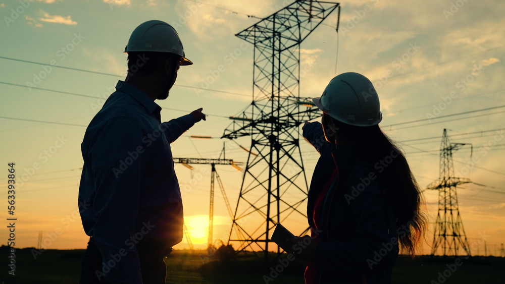 Team of power engineers builders, woman, man, are working together on