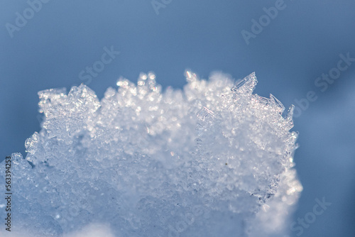 Snow as background, closeup view. Winter weather. Spring grainy blue snow background