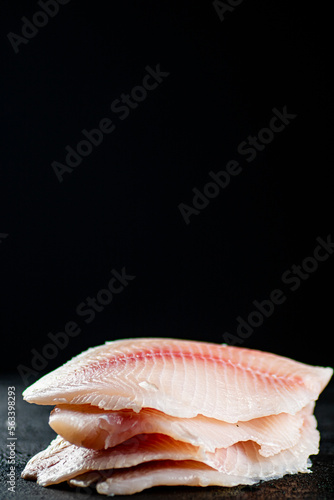 Uncooked fish fillet on the table. 