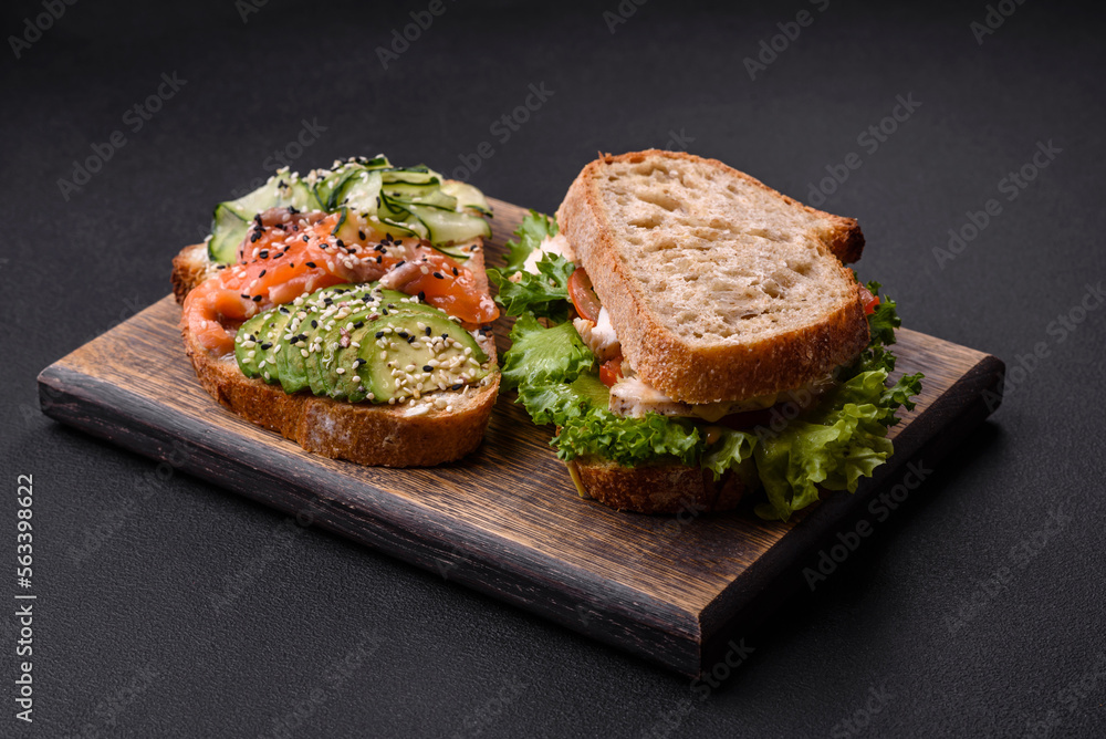 Fresh tasty sandwich with salmon, avocado and sesame and flax seeds Fresh tasty sandwich with salmon, avocado and sesame and flax seeds