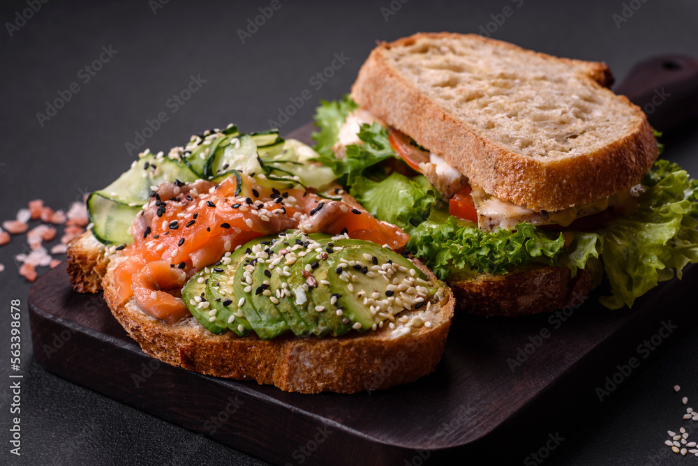 Fresh tasty sandwich with salmon, avocado and sesame and flax seeds