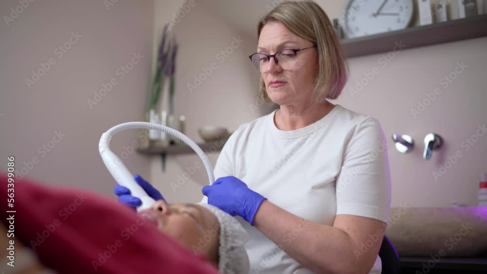 Hardware cosmetology. Hardware cleaning of the face of an Asian woman Hardware cosmetology. Hardware cleaning of the face of an Asian woman