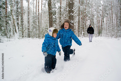 Children play in the winter in the forest.