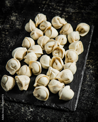 Raw dumplings on a stone board. 