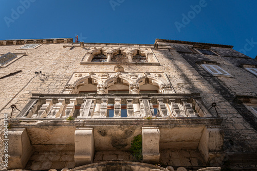 Looking up at ancient palace building facade in the Old City of Trogir, Croatia