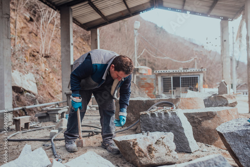 A stone pierces a factory worker. Heavy stone processing industry © Minet