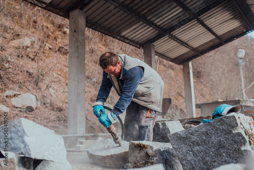 A stone pierces a factory worker. Heavy stone processing industry