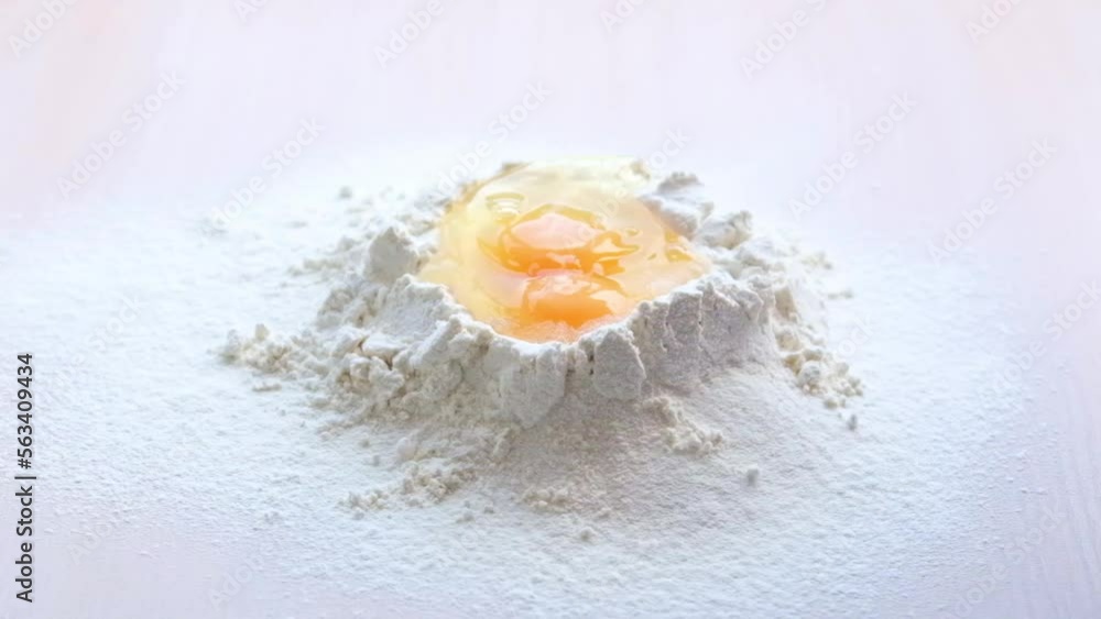 ideal video for advertising cooking show for cooking blog cooking desserts and restaurant eggs falling into flour splashed in slow motion inside flour crumbles on sides white background ideal video for advertising cooking show for cooking blog cooking desserts and restaurant eggs falling into flour splashed in slow motion inside flour crumbles on sides white background