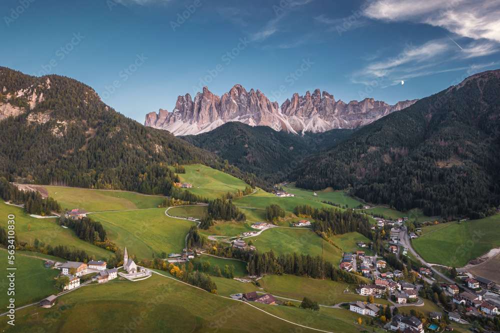 Aerial view of the beautiful small village in Val di Funes, with church and mountains in Dolomite Alps, Italy