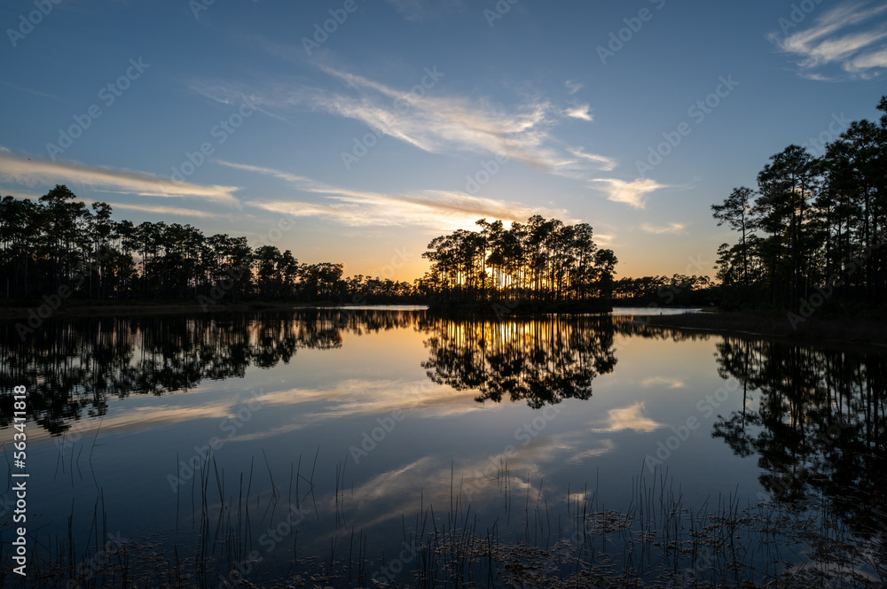 Obraz premium Sunset cloudscape over and reflected in water at Long Pine Key in Everglades National Park, Florida.