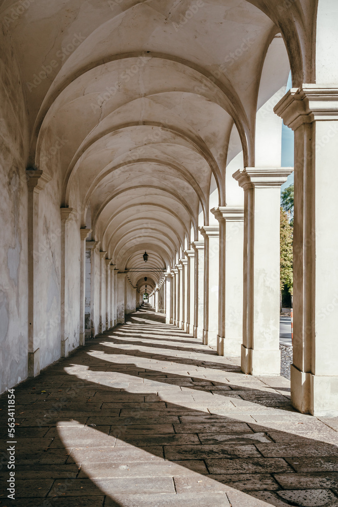 Historic buildings, Marble corridor in sunlight, Arcades of Mount Berico in Vicenza, Italy
